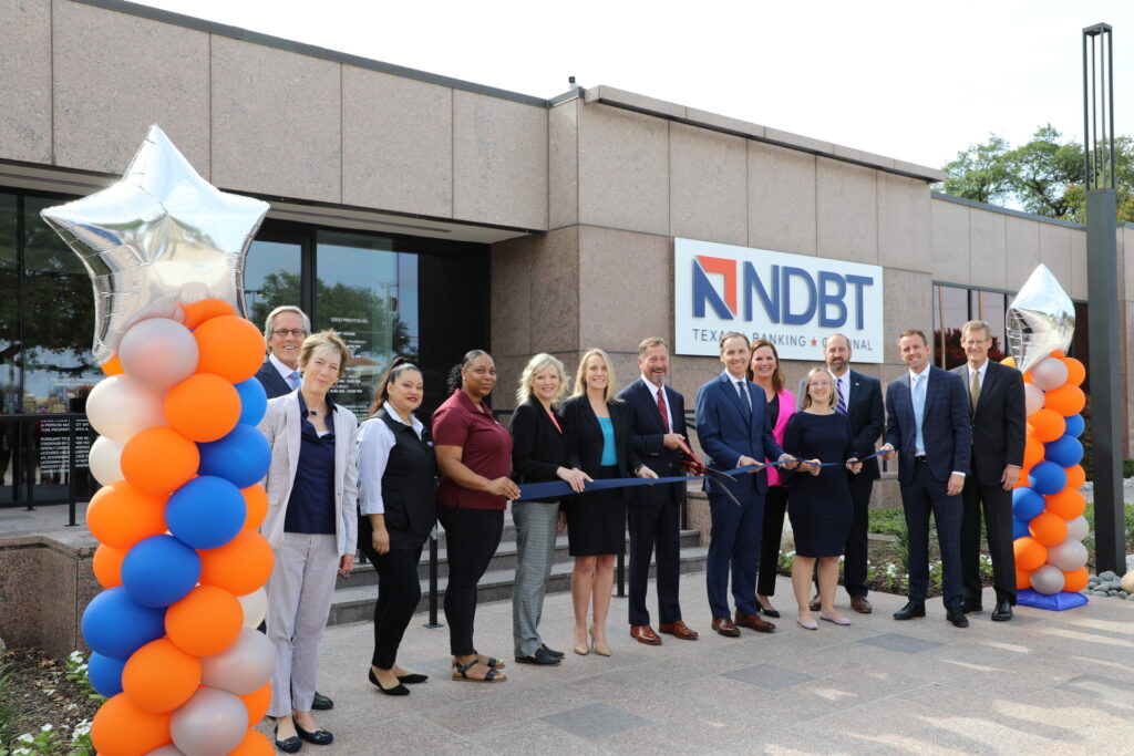 NDBT group photo of ribbon cutting in front of the renovated Dallas Banking center