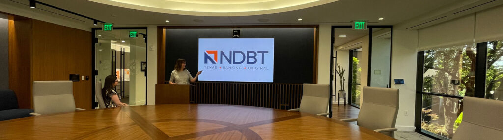 C-Suite member presenting in NDBT's board room.
