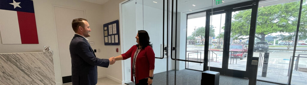 Banker greeting customer in Dallas Banking Center lobby.