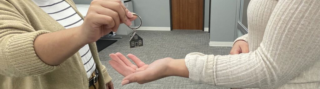 Lender placing house keys in customer's hand.