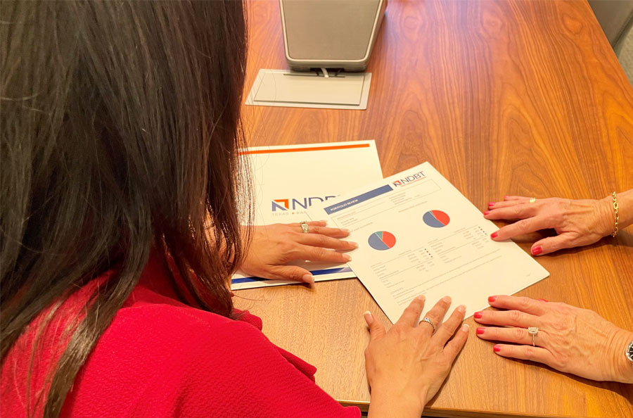 Client reviewing their portfolio in the NDBT Trust and Wealth Management office