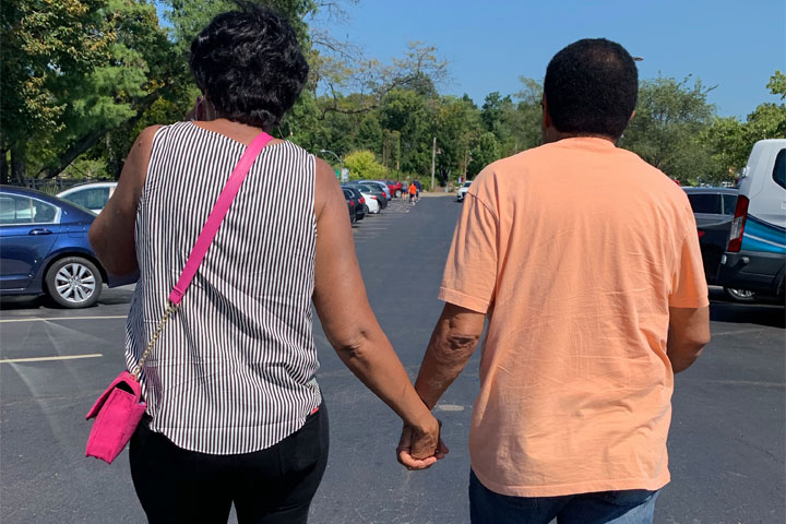 Haley Ellison's parents holding hands while walking