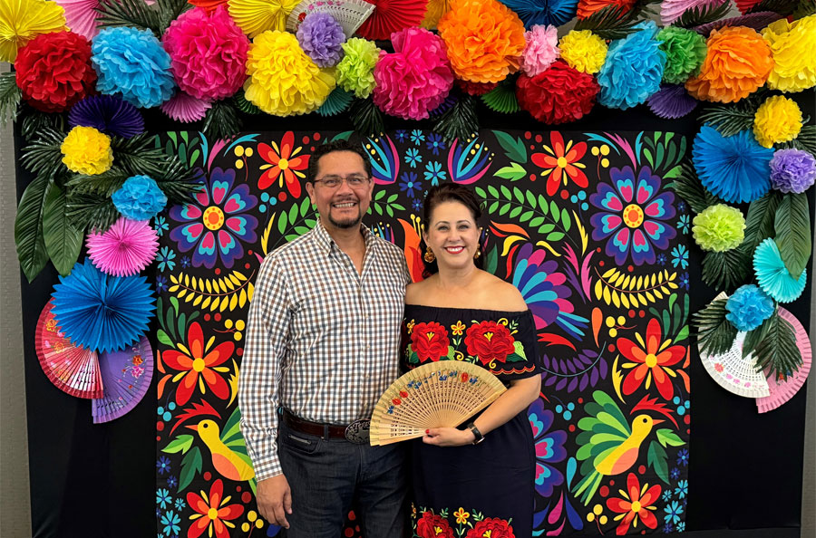 NDBT Business Development Officer Michelle Mercado with husband in front of Hispanic Heritage backdrop