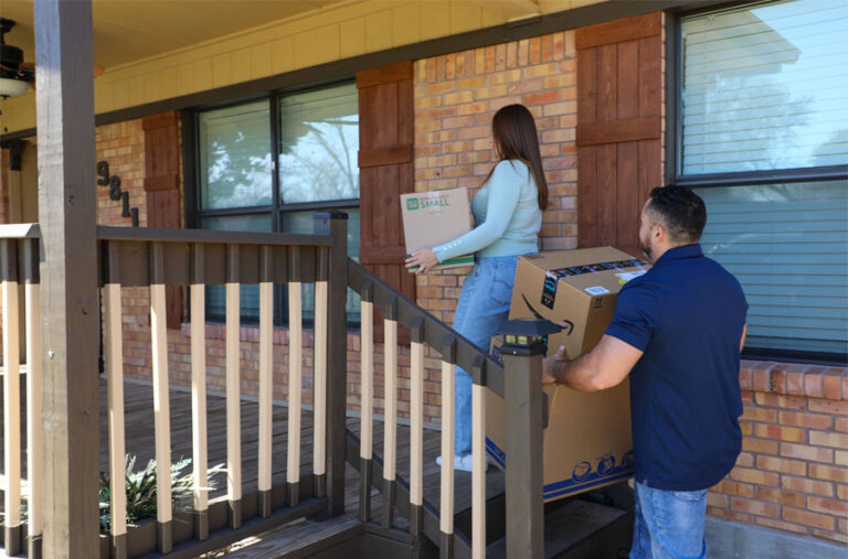 Home owners moving boxes into new home