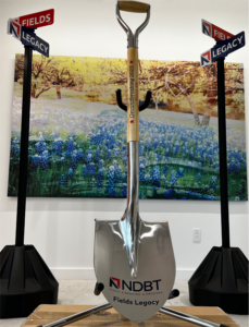 Groundbreaking shovel and two Fields/Legacy street signs