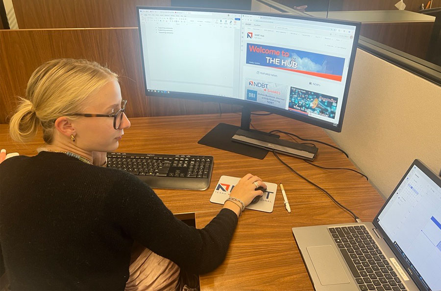 NDBT Intern Caroline Dwight working at her desk