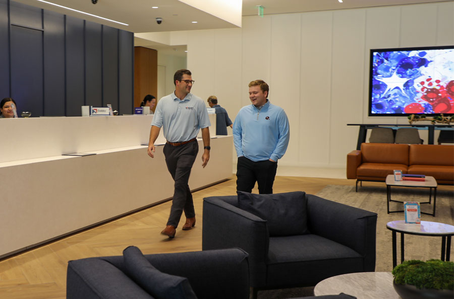 NDBT Intern Kiyan Phelps in the Dallas Banking Center lobby with lender Sam Gunn