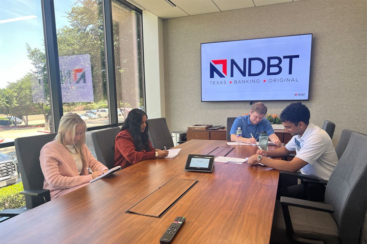 NDBT Interns working in bank conference room
