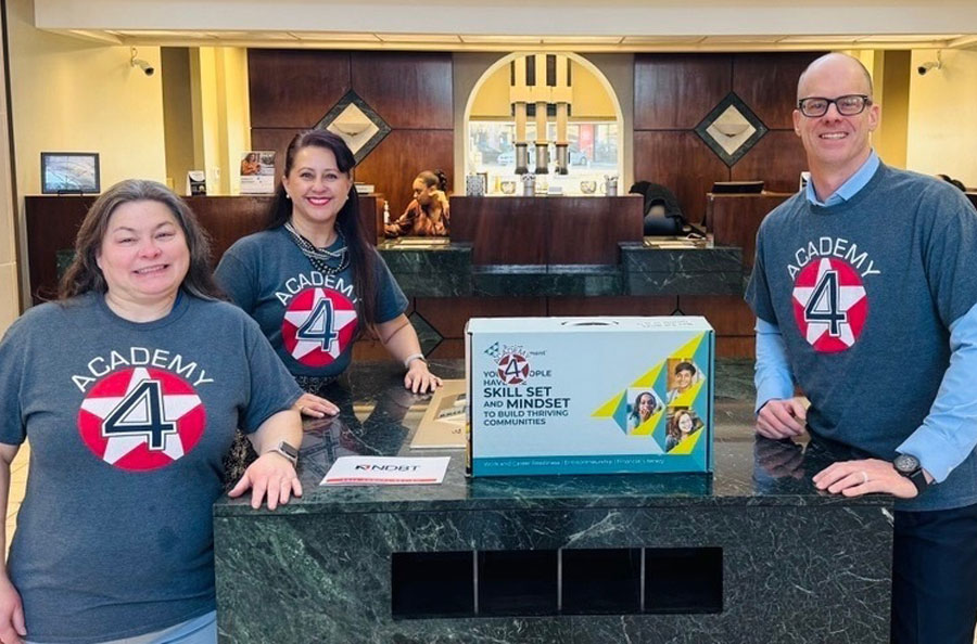 NDBT employees pictured together wearing Academy 4 t-shirts